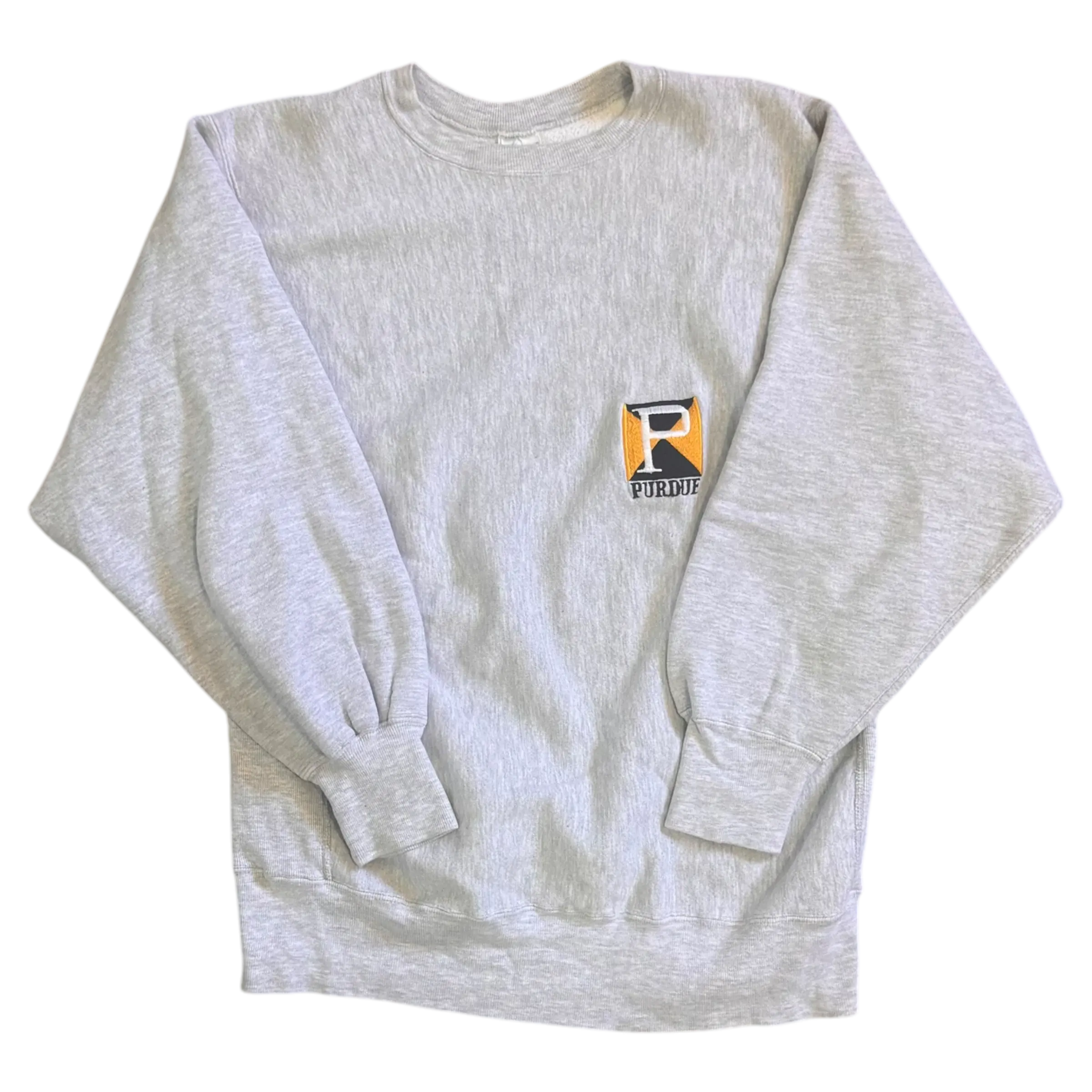 Champion Reverse Weave Crewneck in grey featuring a small embroidered Purdue emblem on the chest, ideal for Purdue fans seeking a classic and durable sweatshirt.